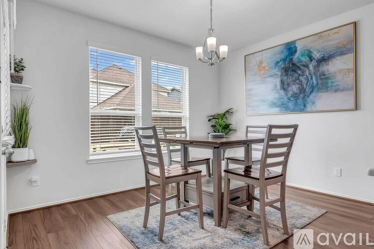 A dining room with a wooden table and chairs.