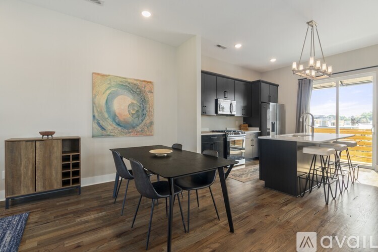 A modern kitchen with a dining table and chairs.