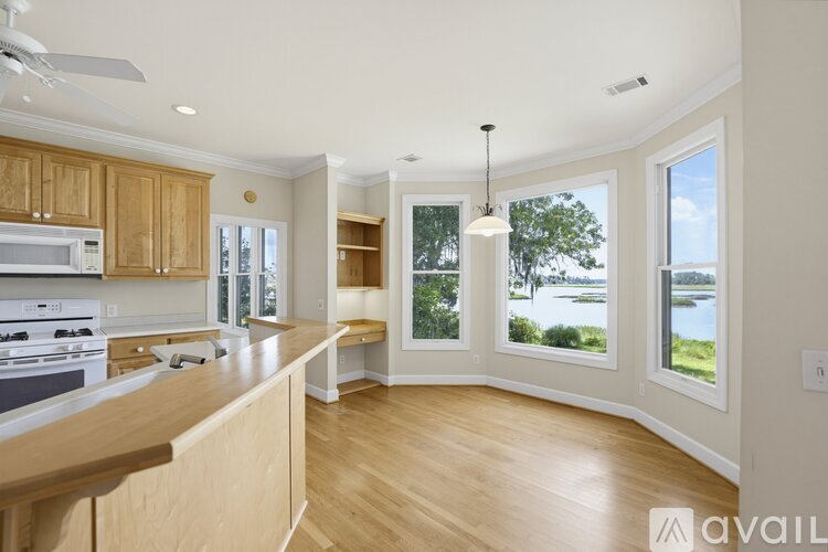 A kitchen with wooden cabinets and a large island with a countertop.