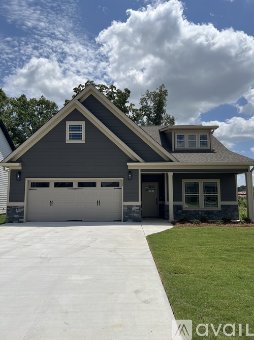 A house with a grey garage door and a grey roof.