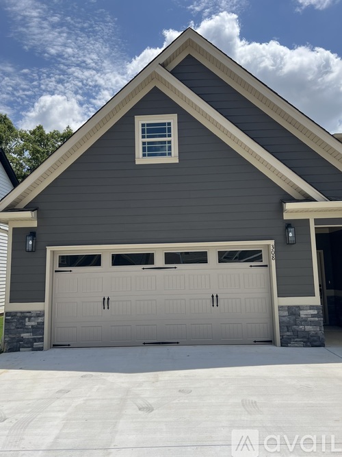 A two-car garage is attached to a house.
