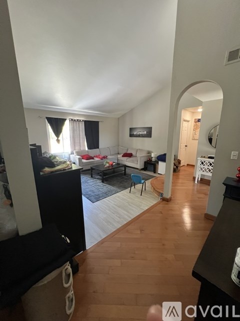 A living room with a couch and a television.