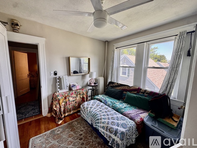 A bedroom with two beds and a ceiling fan.
