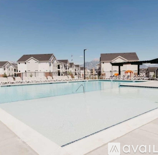 A large swimming pool in front of a row of houses.