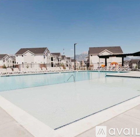 A large swimming pool in front of a row of houses.