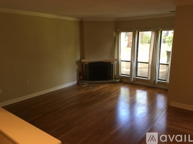 A living room with a television and sliding glass doors.