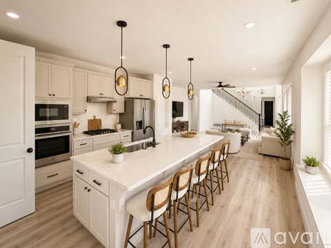 A modern kitchen with a long island and wooden chairs.