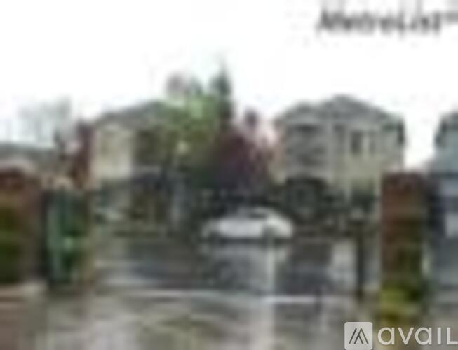 A blurry image of a residential area with houses and trees.