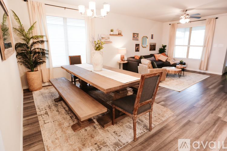 A modern dining room with a wooden table and chairs.