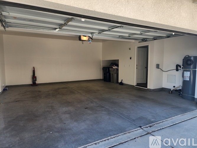 A spacious garage with a fire extinguisher on the wall.