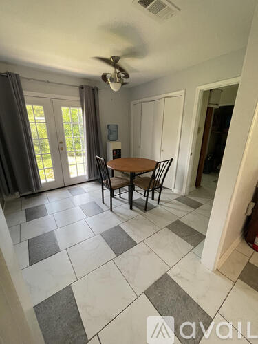 A dining room with a table and chairs.