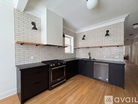 A kitchen with black countertops and white cabinets.