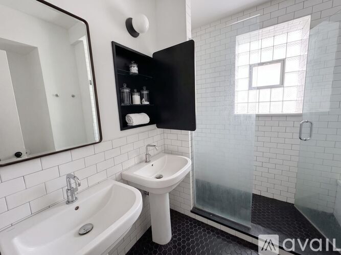 A bathroom with a white sink and a white tub.