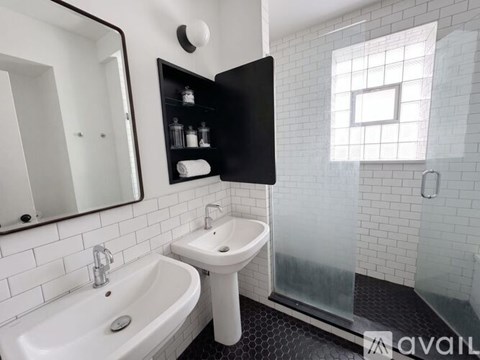 A bathroom with a white sink and a white tub.