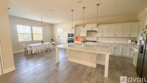 A kitchen with a dining table and chairs is available for rent.