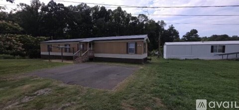 A mobile home with a brown and beige exterior is available for rent.