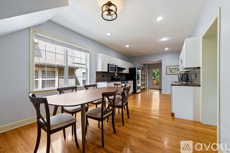 A dining room with a table and chairs is available for rent.