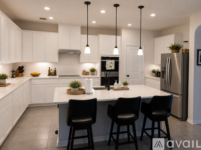 A modern kitchen with white cabinets and a central island.