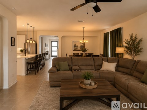 A modern living room with a large sectional sofa and a wooden coffee table.