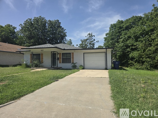 A house with a white garage door is for sale.