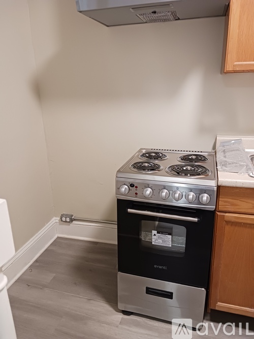 A black oven with a stove on top is in a kitchen.