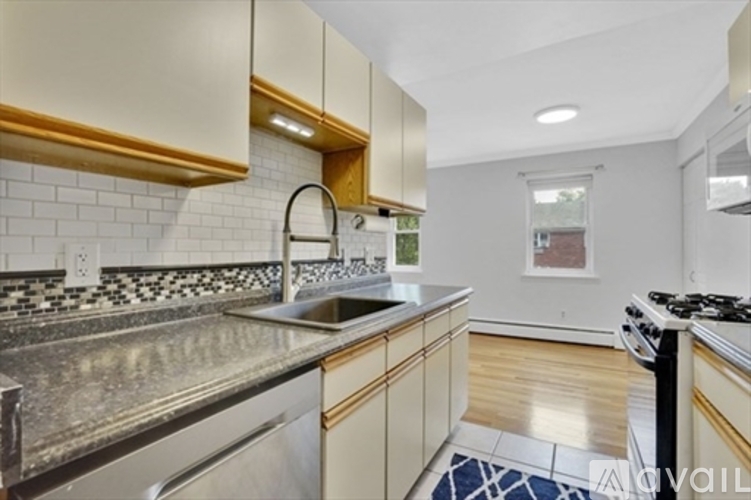 A kitchen with a stove top oven and a sink.