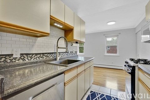 A kitchen with a stove top oven and a sink.