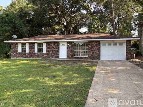 A house with a white garage door and a brick exterior.