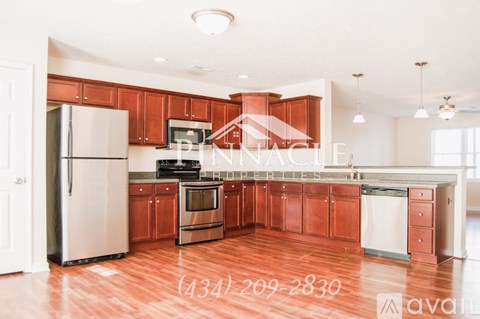A kitchen with wooden cabinets and a refrigerator.