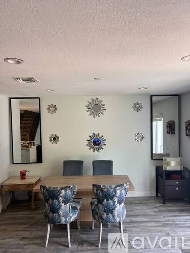 A dining room with a wooden table and chairs.