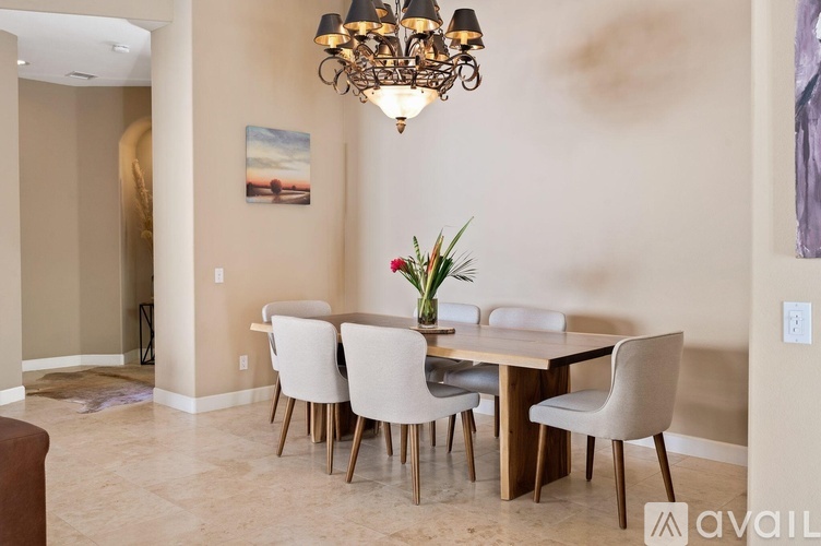 A dining room with a table set for four.