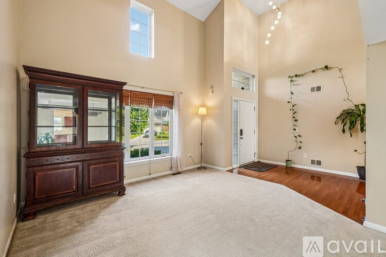 A living room with a wooden cabinet and a carpeted floor.