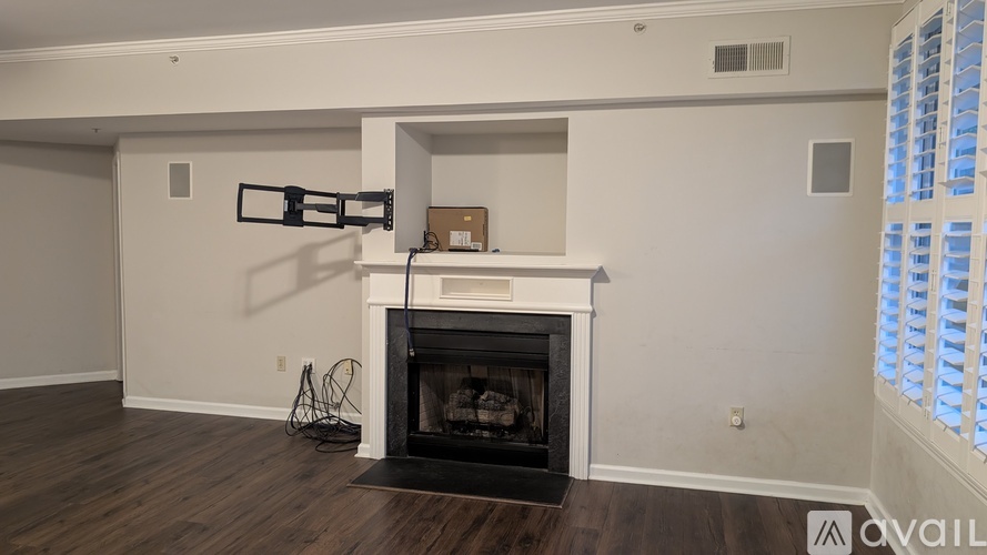 A modern living room with a fireplace and a wall-mounted TV.