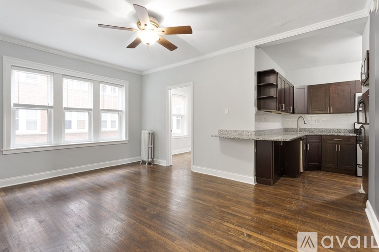 A room with wooden floors and a ceiling fan.