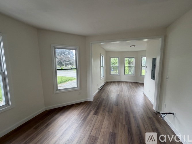 A room with wooden floors and white walls.