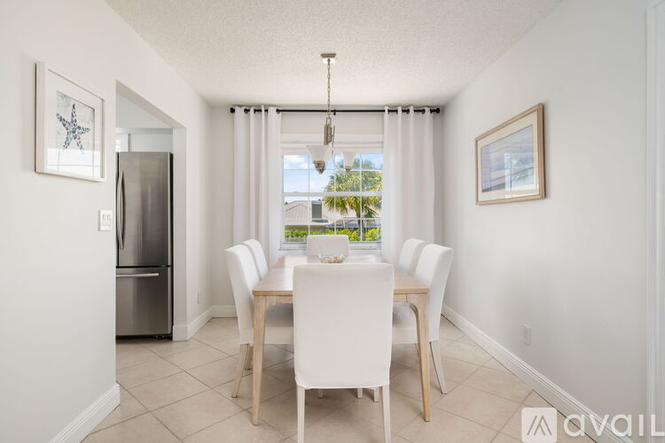 A dining room with a table set for four.