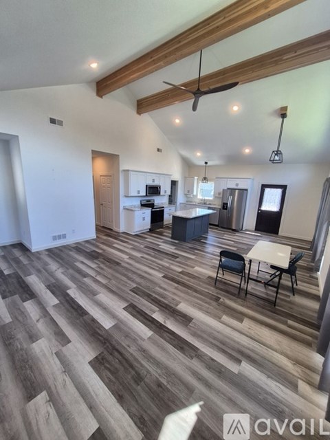 A modern kitchen with a dining table and chairs.