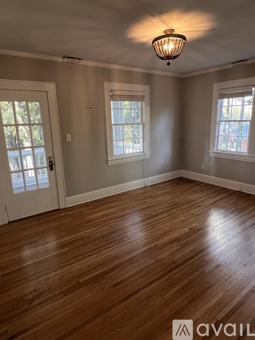 A room with wooden floors and a ceiling light.