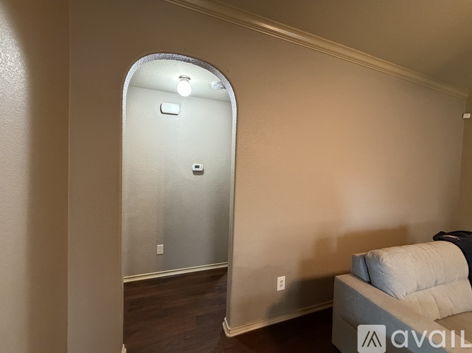 A room with a couch and a mirror on the wall.