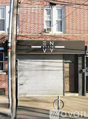 A sign that says "EN BRAID VVY" is hanging on a building.