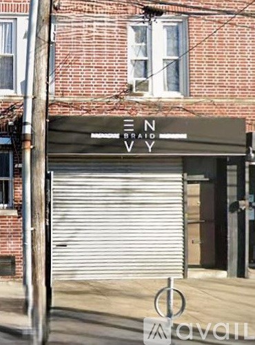 A sign that says "EN BRAID VVY" is hanging on a building.