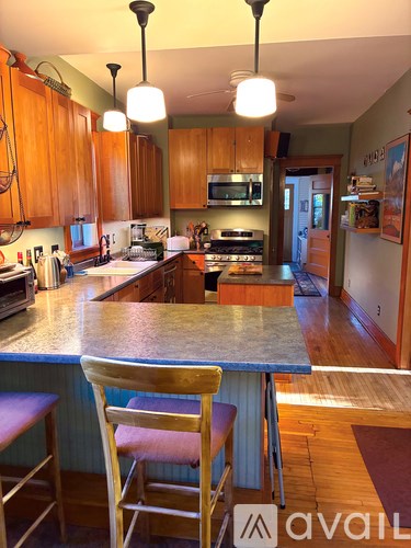 A kitchen with wooden cabinets and a granite countertop.