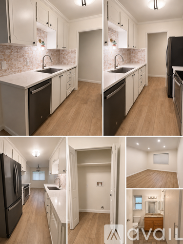 A kitchen with white cabinets and a black refrigerator.
