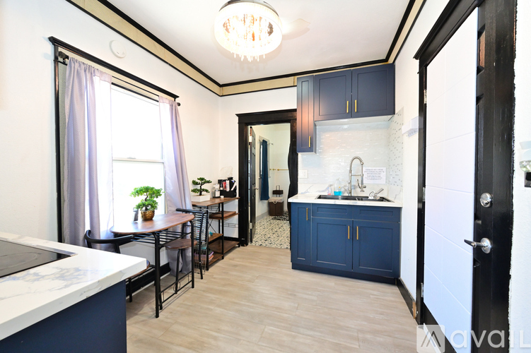 A kitchen with a table and chairs by a window.