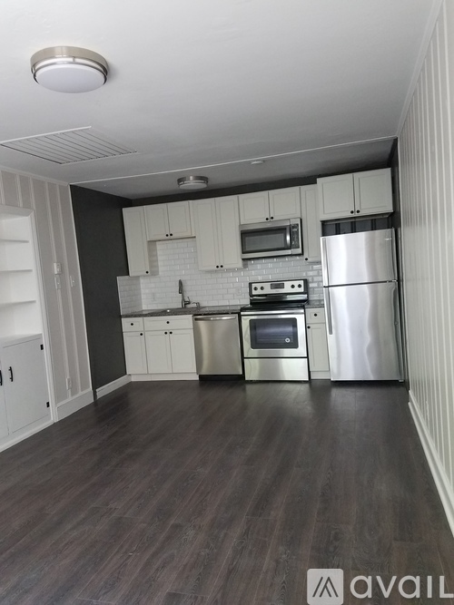 A kitchen with white cabinets and stainless steel appliances.