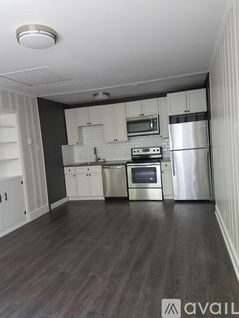 A kitchen with white cabinets and stainless steel appliances.
