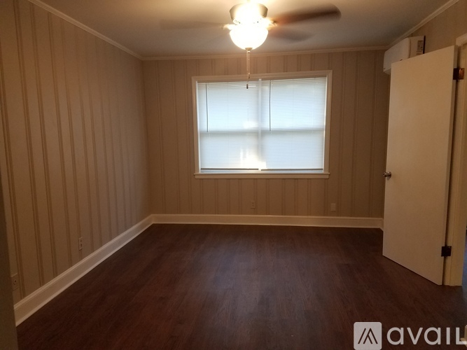 A room with wooden walls and a ceiling fan.