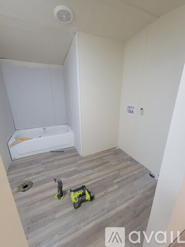 A room with a white ceiling and a white door with a small window.