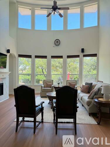 A living room with two chairs and a table.