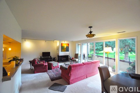 A living room with a red couch and a television.